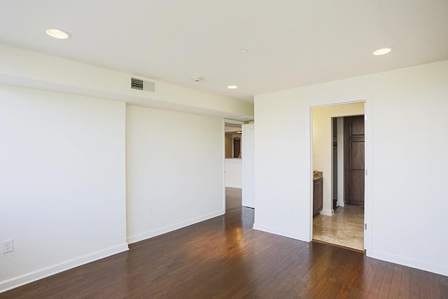 spare room featuring dark hardwood / wood-style floors