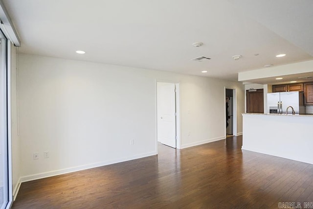 unfurnished living room featuring dark hardwood / wood-style floors