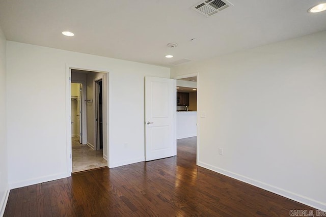 spare room featuring dark wood-type flooring