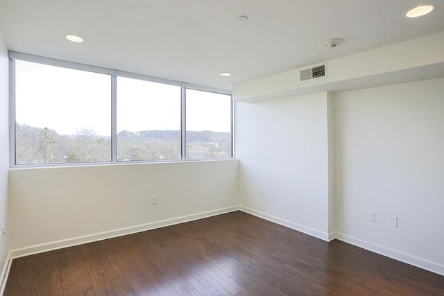 empty room with dark hardwood / wood-style floors