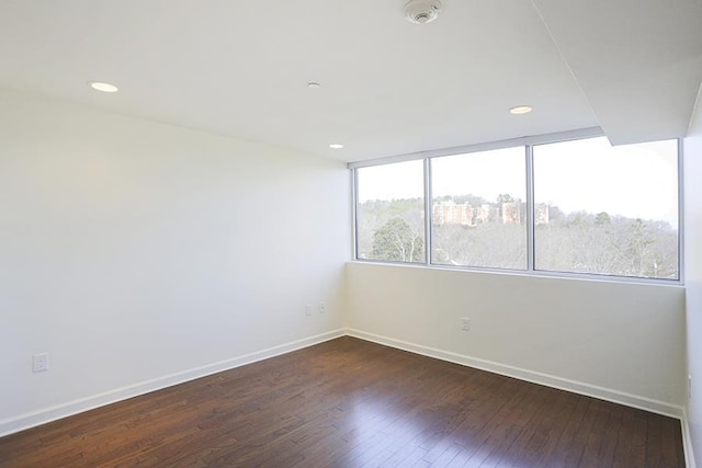 unfurnished room featuring dark hardwood / wood-style floors