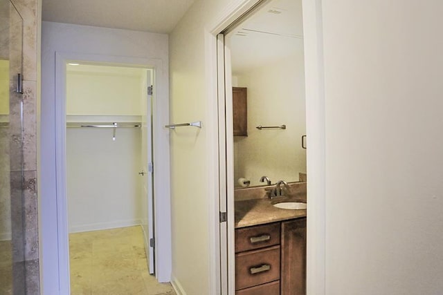 bathroom with an enclosed shower and vanity