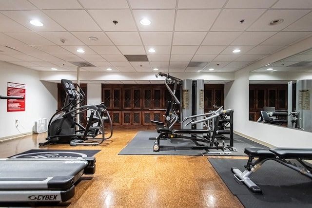 workout area with a paneled ceiling