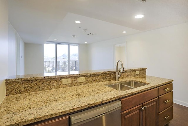 kitchen featuring stainless steel dishwasher, dark hardwood / wood-style flooring, light stone countertops, and sink