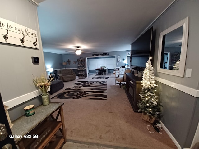 living room featuring ceiling fan and carpet flooring