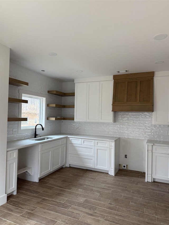 kitchen with sink, decorative backsplash, and white cabinets