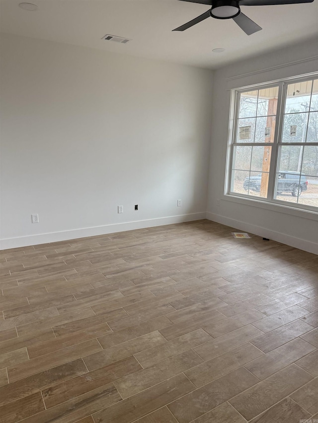 empty room featuring ceiling fan and light hardwood / wood-style flooring