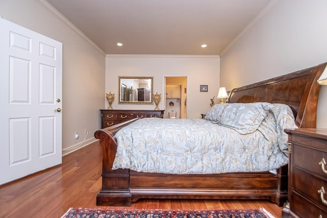 bedroom featuring crown molding and hardwood / wood-style flooring