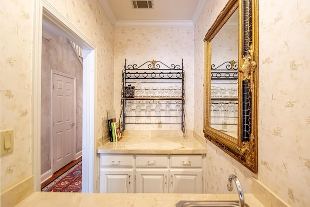 interior space featuring vanity and ornamental molding