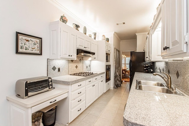 kitchen featuring black oven, stainless steel gas stovetop, white cabinetry, sink, and light tile patterned floors