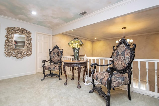 sitting room with crown molding, carpet floors, and a chandelier