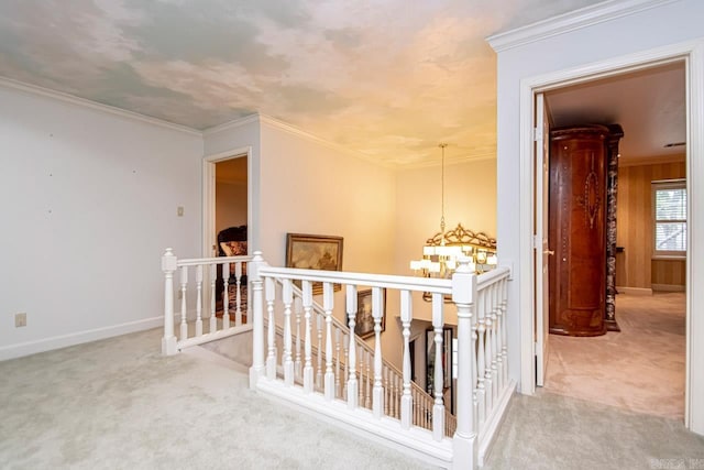 corridor with crown molding, a chandelier, and light carpet