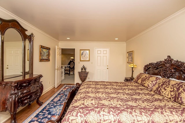 bedroom featuring hardwood / wood-style flooring and crown molding