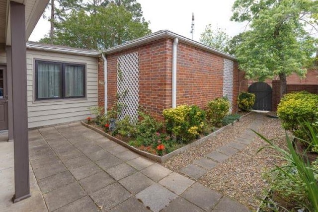 view of side of home with a patio area