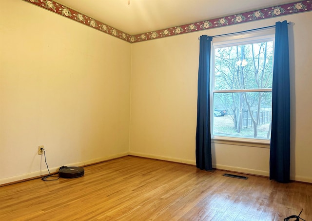 unfurnished room with plenty of natural light and light hardwood / wood-style floors