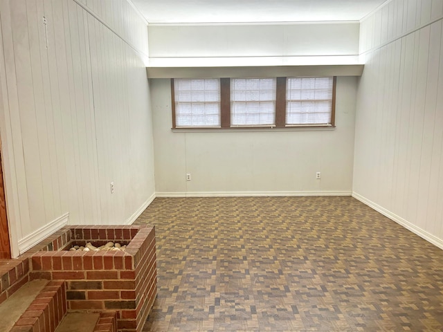 empty room featuring plenty of natural light and dark parquet floors