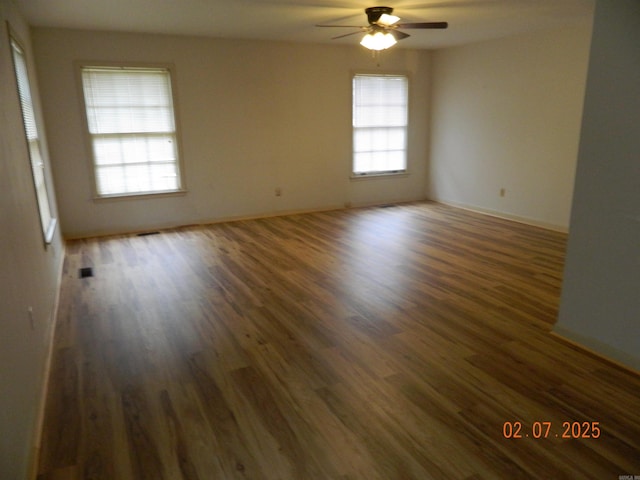 unfurnished room featuring dark hardwood / wood-style floors and ceiling fan