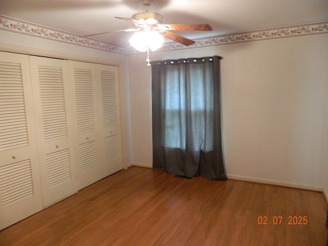 unfurnished bedroom with ceiling fan, hardwood / wood-style floors, and a closet