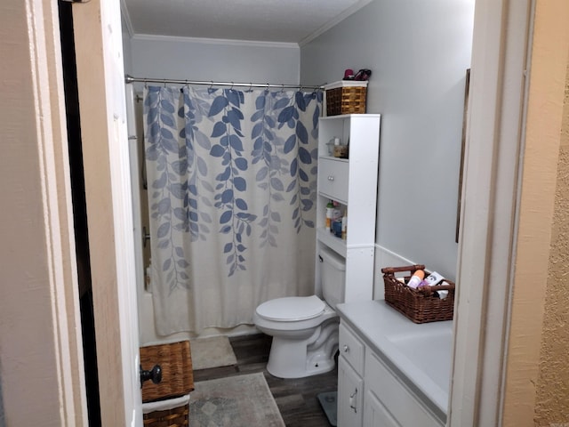 full bathroom with hardwood / wood-style floors, shower / tub combo with curtain, ornamental molding, vanity, and toilet