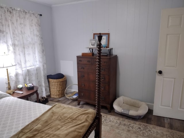 bedroom with wood-type flooring and crown molding