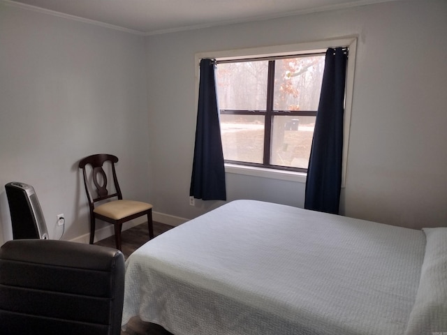 bedroom featuring hardwood / wood-style floors and ornamental molding