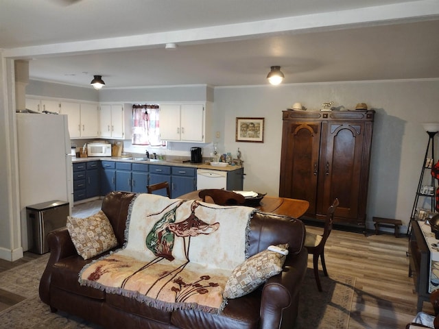 living room with sink, dark wood-type flooring, and ornamental molding