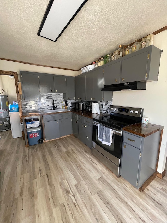 kitchen featuring stainless steel range with electric stovetop, gray cabinets, water heater, and light wood-type flooring