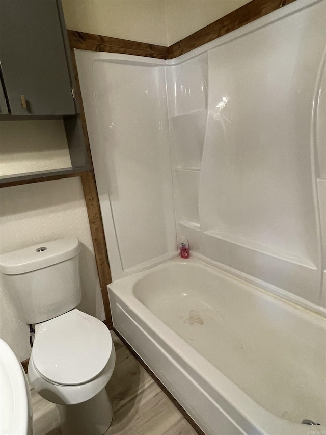 bathroom featuring hardwood / wood-style floors, toilet, and shower / bath combination