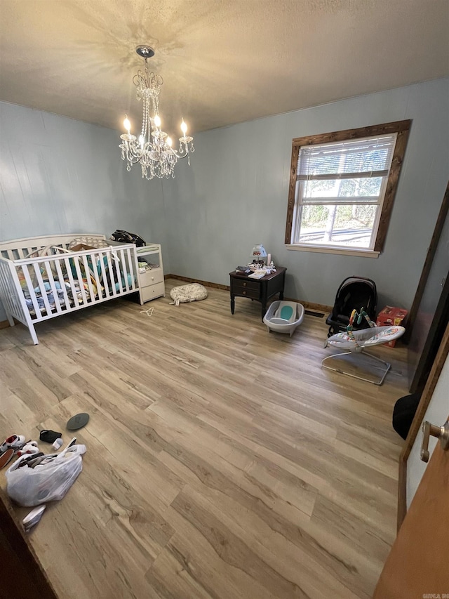 bedroom featuring hardwood / wood-style flooring and a chandelier