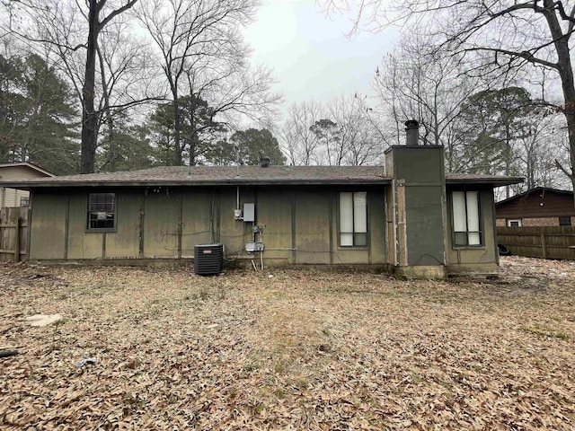 rear view of house featuring central AC