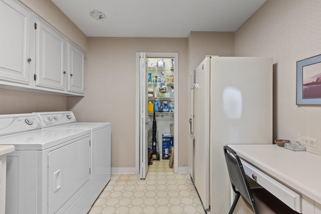 laundry room with washer and clothes dryer and cabinets