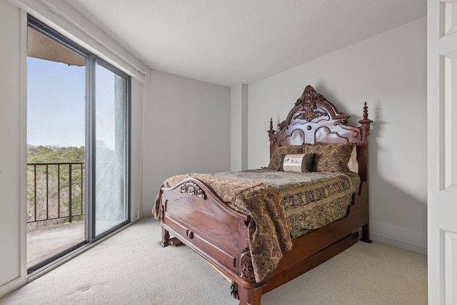 carpeted bedroom with multiple windows and access to exterior