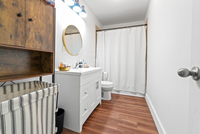 bathroom featuring vanity, hardwood / wood-style floors, toilet, and a shower with shower curtain