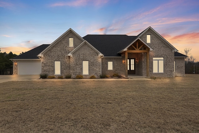 craftsman-style home with a garage and a lawn