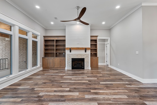 unfurnished living room featuring dark hardwood / wood-style flooring, ornamental molding, and ceiling fan