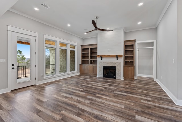 unfurnished living room with dark wood-type flooring, ceiling fan, and ornamental molding