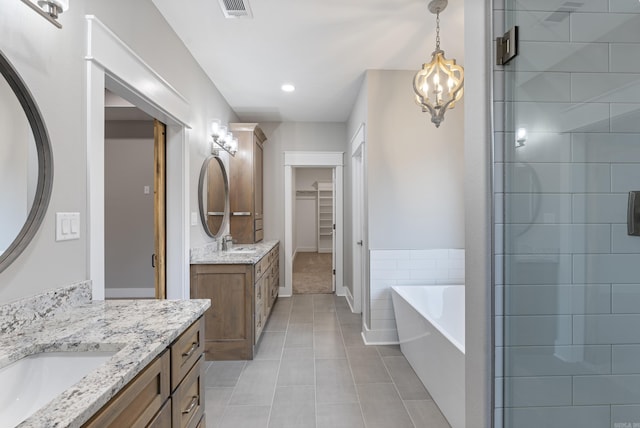 bathroom with vanity, tile patterned floors, and plus walk in shower