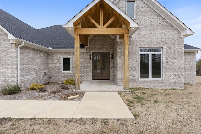 view of exterior entry with a patio area and french doors