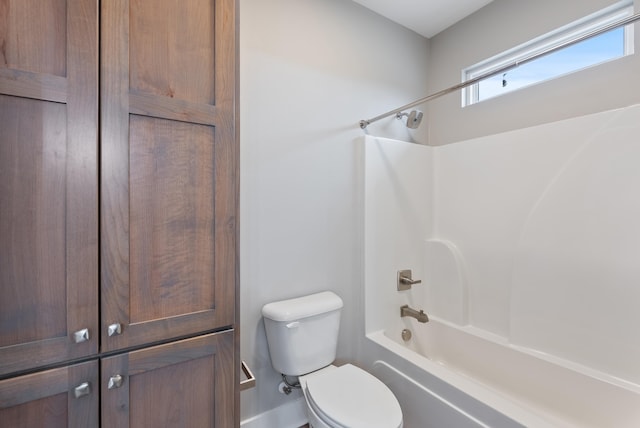 bathroom with washtub / shower combination and toilet