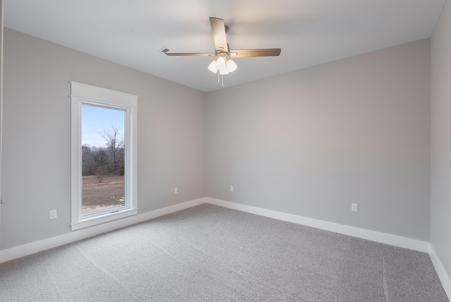 empty room featuring carpet floors and ceiling fan