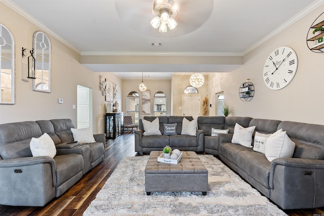 living room with dark hardwood / wood-style flooring, crown molding, and ceiling fan