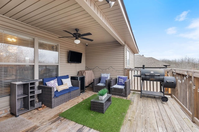 wooden terrace with an outdoor hangout area and ceiling fan