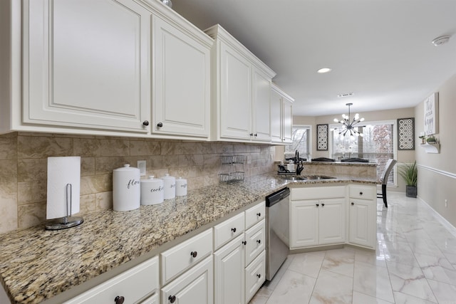 kitchen with dishwasher, sink, kitchen peninsula, and white cabinets