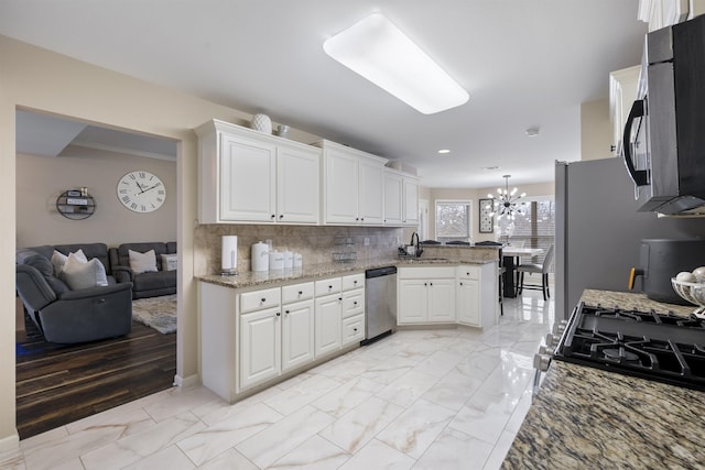 kitchen with a notable chandelier, stainless steel dishwasher, and white cabinets