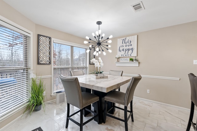 dining space featuring an inviting chandelier and plenty of natural light