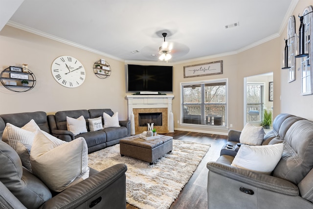 living room featuring crown molding, ceiling fan, and dark hardwood / wood-style floors