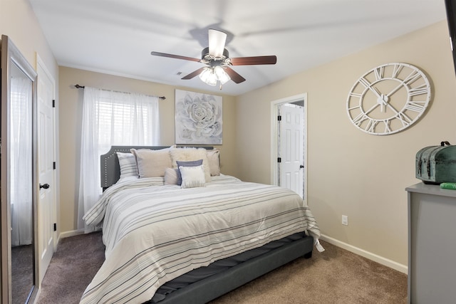 bedroom with ceiling fan and dark colored carpet