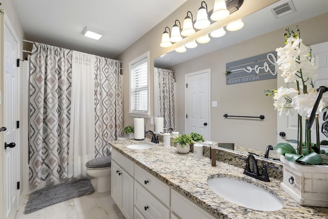 full bathroom with vanity, shower / bath combo with shower curtain, and toilet