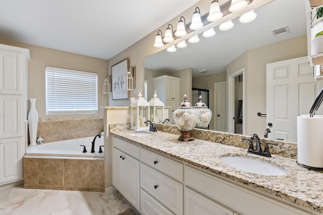 bathroom with vanity and a relaxing tiled tub