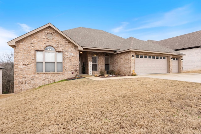 view of front of house with a garage and a front yard